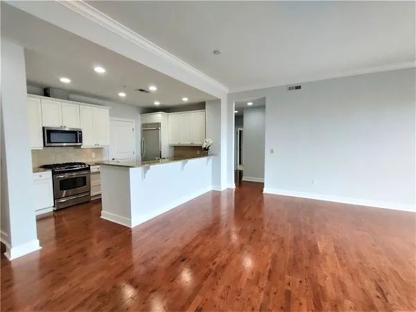 a view of kitchen with microwave and refrigerator