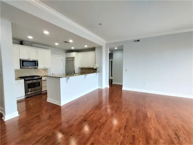 a view of kitchen with microwave and refrigerator