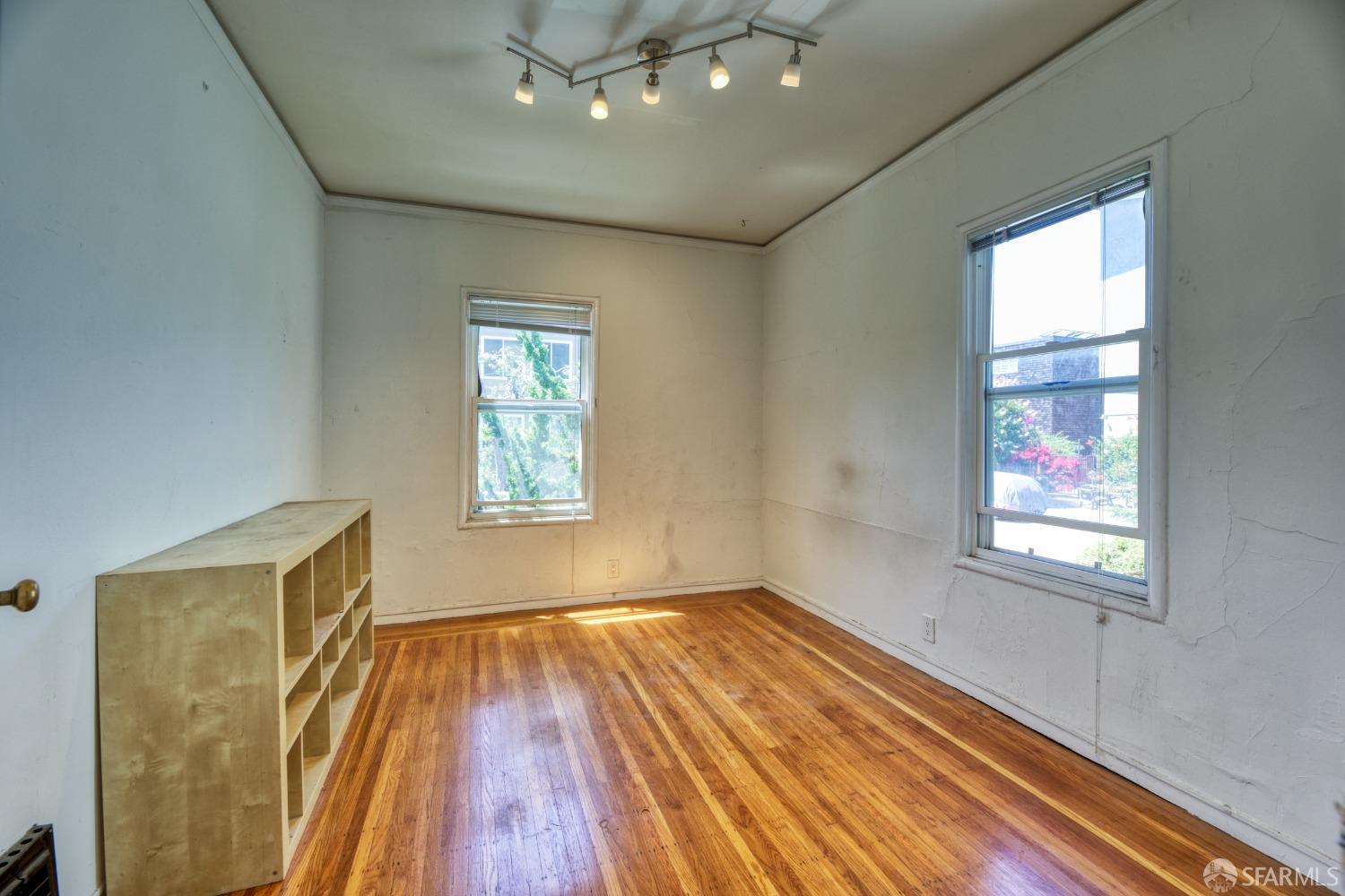 1334-1336 Walnut Street Berkeley, CA 94709 - Photo 11 of 18 a view of an empty room with wooden floor and a window