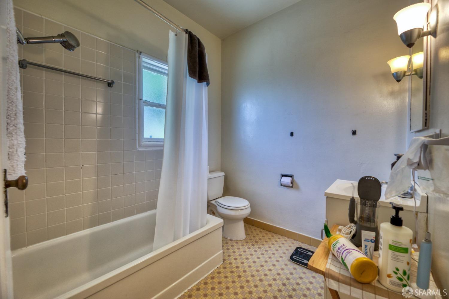 1334-1336 Walnut Street Berkeley, CA 94709 - Photo 13 of 18 a bathroom with a sink toilet and shower