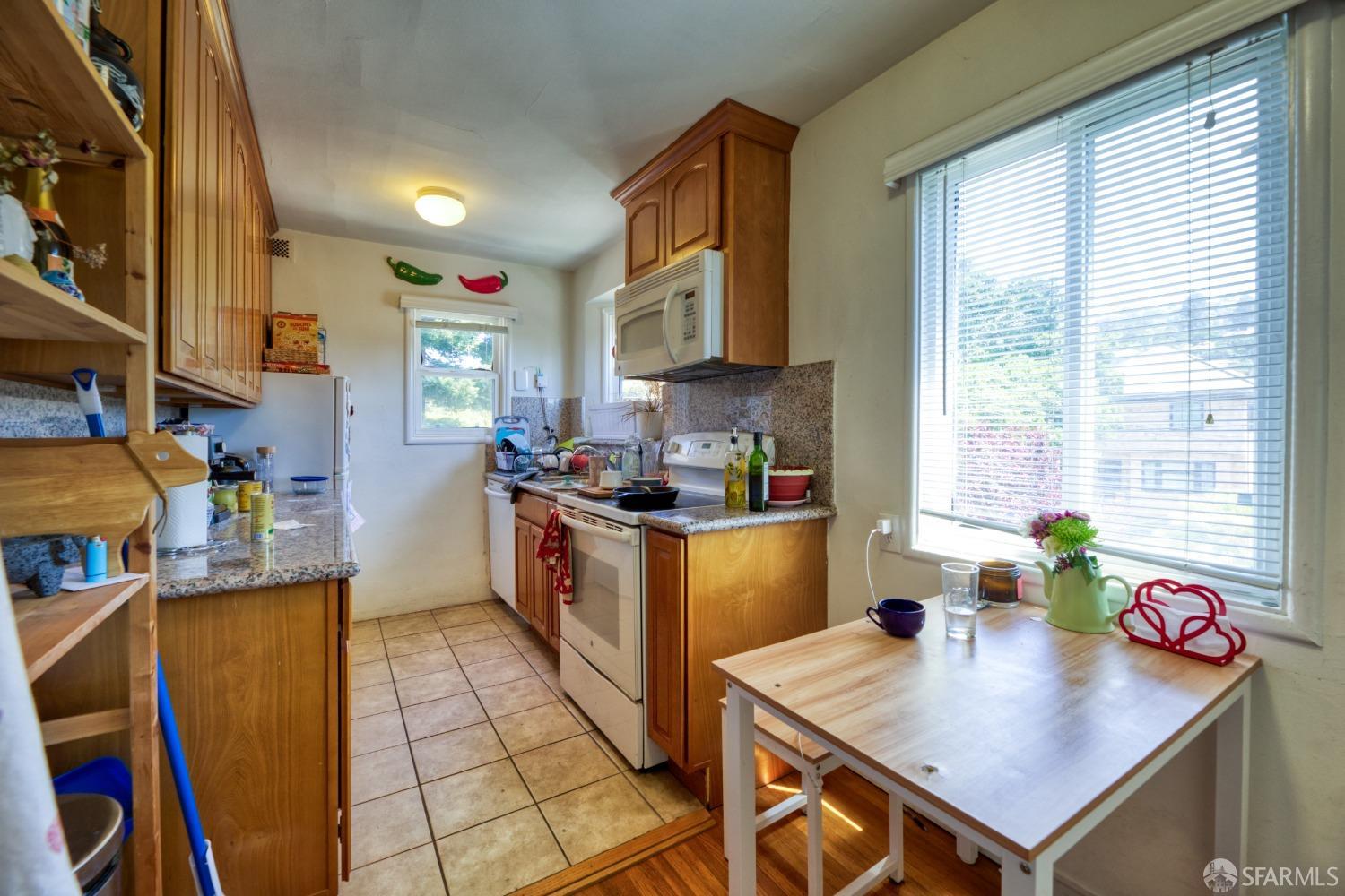 1334-1336 Walnut Street Berkeley, CA 94709 - Photo 15 of 18 a kitchen with stainless steel appliances a stove a sink and a refrigerator