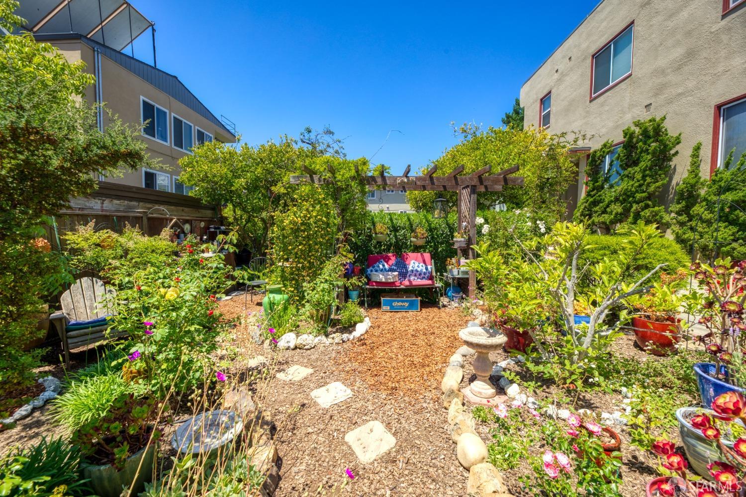 1334-1336 Walnut Street Berkeley, CA 94709 - Photo 17 of 18 a view of a house with a backyard and garden