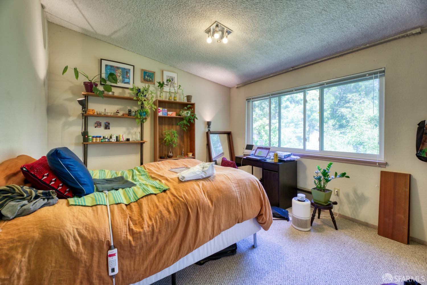 1334-1336 Walnut Street Berkeley, CA 94709 - Photo 7 of 18 a bedroom with a bed and a chandelier