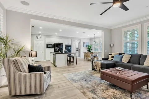 a living room with furniture and view of kitchen