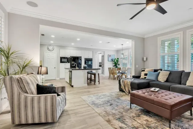 a living room with furniture and view of kitchen