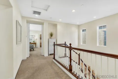 a view of a hallway with closet and stairs