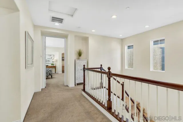 a view of a hallway with closet and stairs