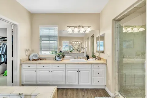 a bathroom with a sink a light fixture and a mirror