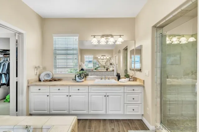 a bathroom with a sink a light fixture and a mirror