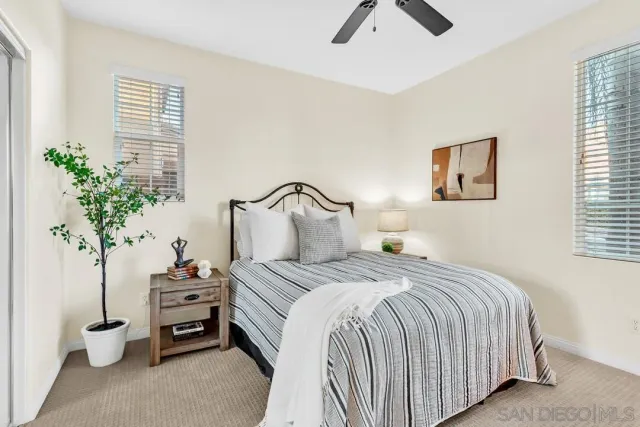 a bedroom with bed and a potted plant