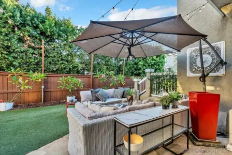 a view of a backyard with a patio and outdoor seating