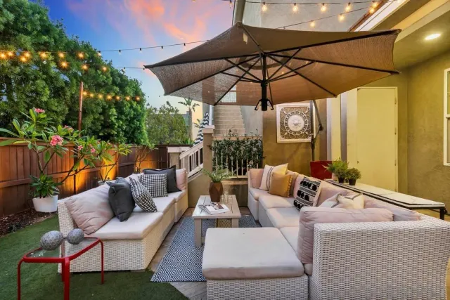 a view of a patio with a table and chairs under an umbrella