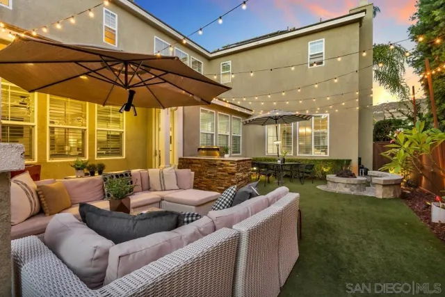 a outdoor living space with furniture and umbrella