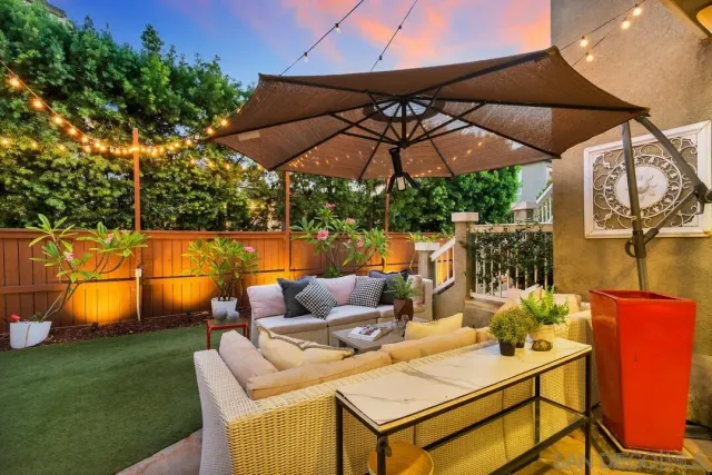 a view of an outdoor sitting area with furniture and umbrella