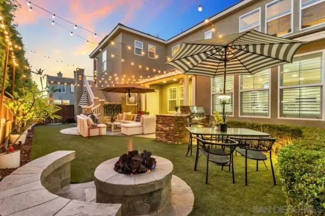 a view of a patio with couches table and chairs and potted plants