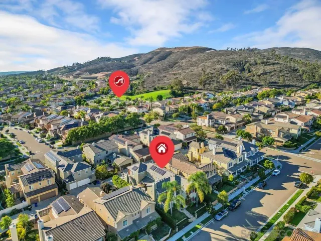 an aerial view of residential houses with outdoor space and seating