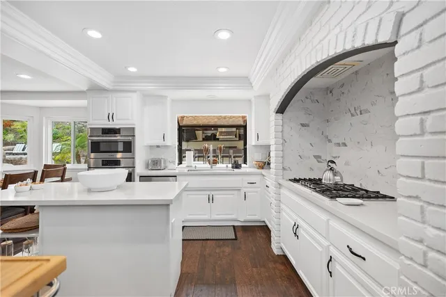 a kitchen with a sink and wooden floor