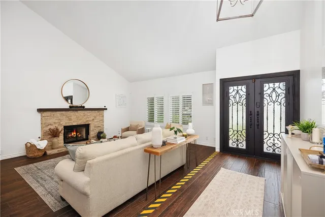 a living room with furniture and a fireplace with wooden floor