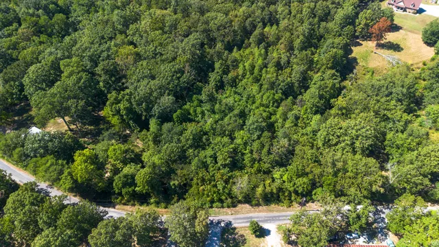 an aerial view of a house with yard
