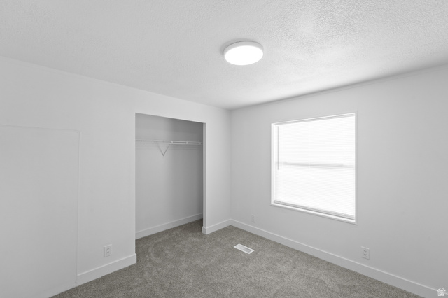 2600 North Hill Field Road, Unit 103A Layton, UT 84041 - Photo 20 of 31 Carpeted room featuring a window with blinds, a wire closet system, white baseboards, and a flush-mount ceiling light fixture
