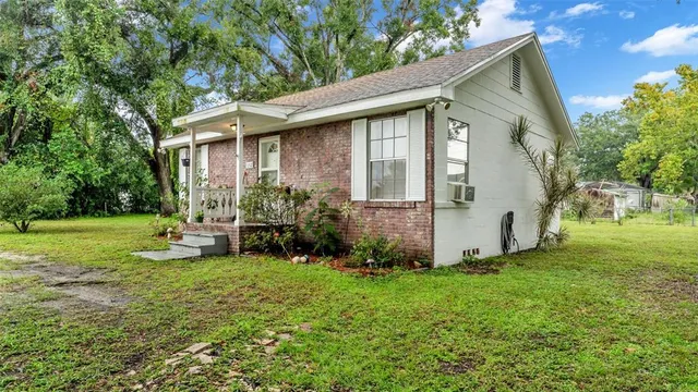 a view of a house with backyard and sitting area