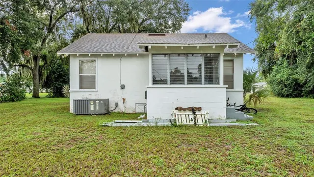 a view of a house with a yard and sitting area