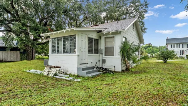 a view of a house with backyard and sitting area