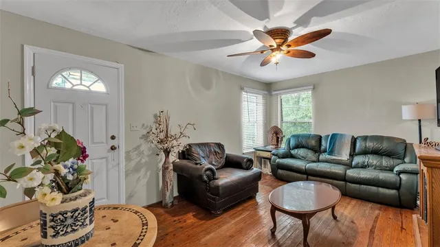 a living room with furniture a chandelier and a window