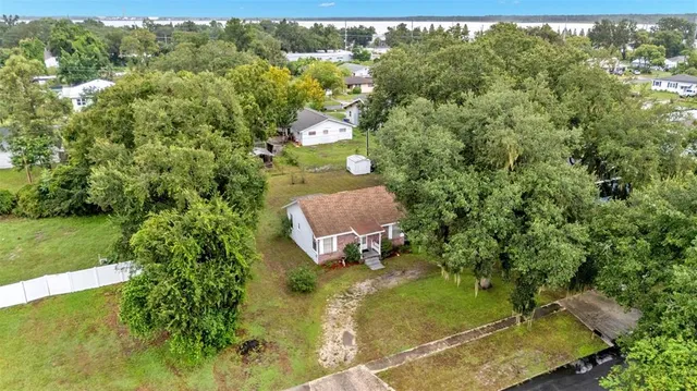 an aerial view of a house with a yard
