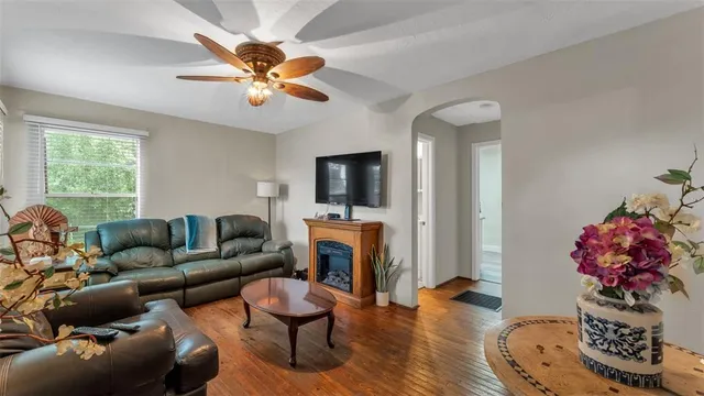 a living room with furniture a fireplace and a flat screen tv