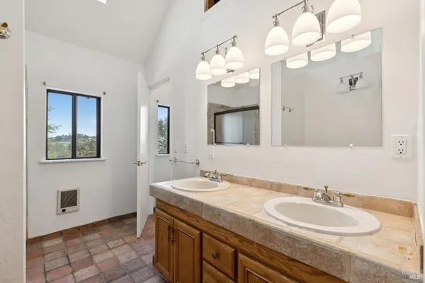 a bathroom with a sink vanity and a mirror