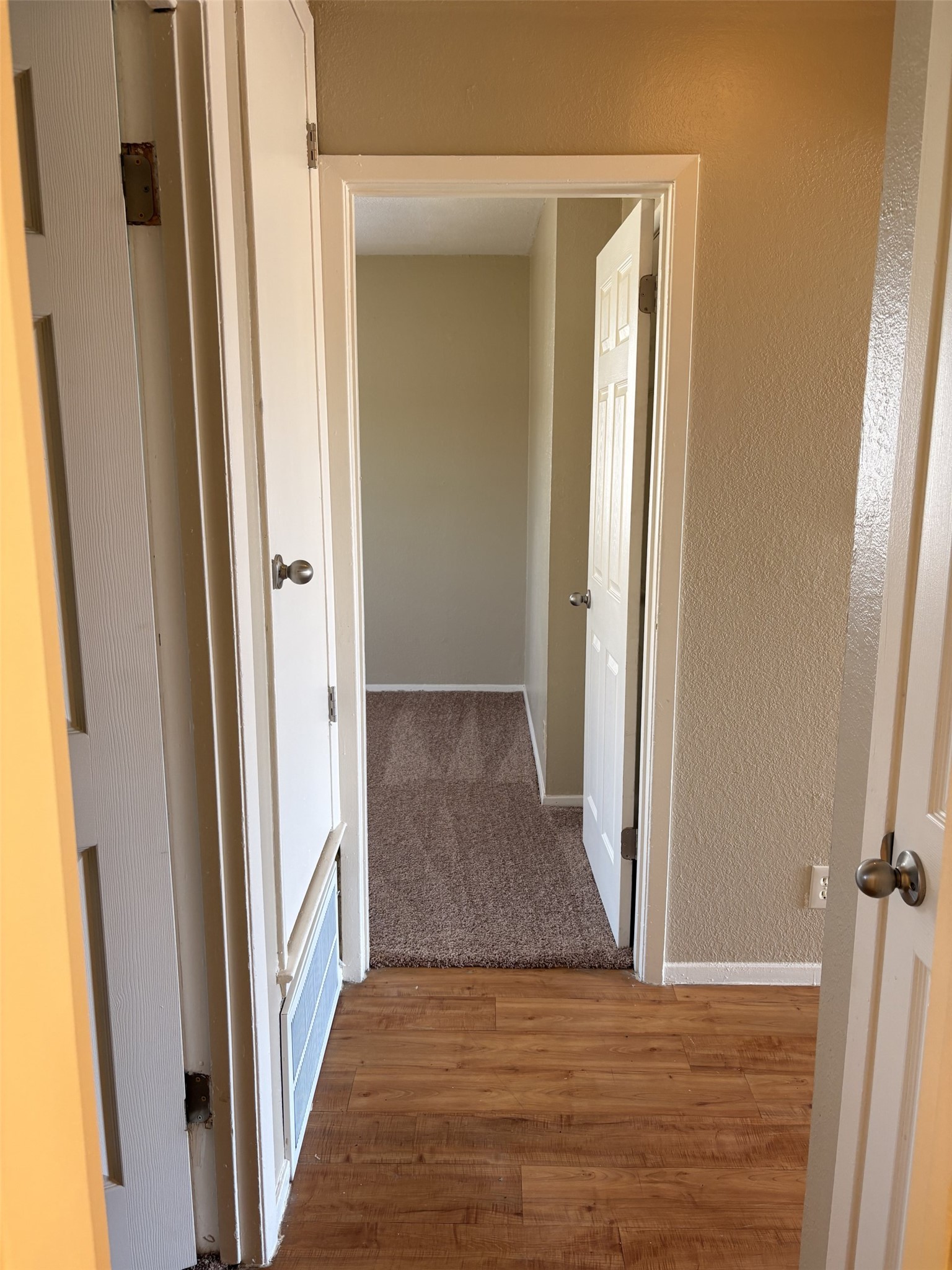 9902 Roxanna Drive, Unit D Austin, TX 78748 - Photo 9 of 19 Hallway with light wood-type flooring and a textured wall