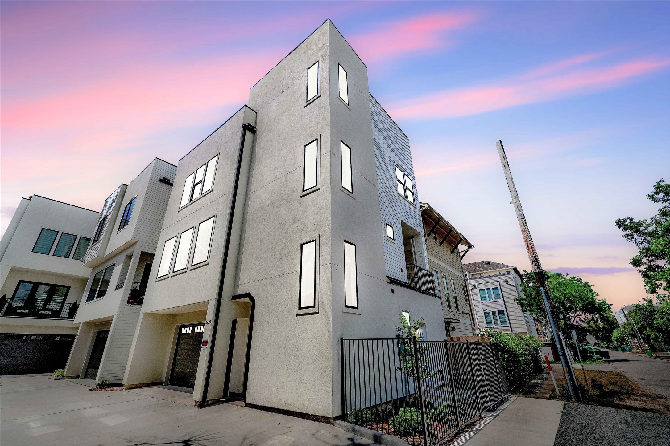 a front view of a multi story residential apartment building with garage