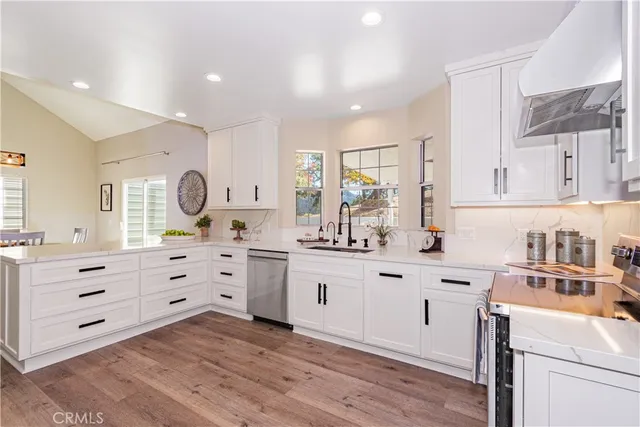 a kitchen with white cabinets and white appliances