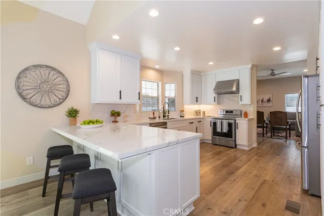 a kitchen with a sink appliances and cabinets