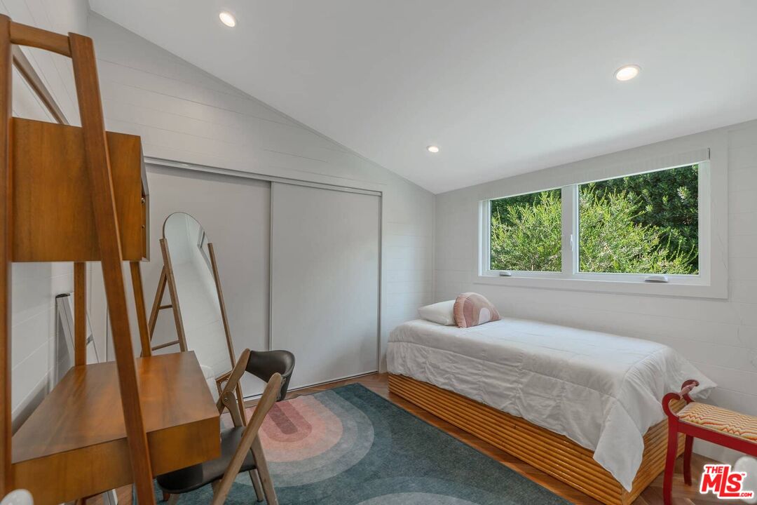 249 Paradise Cove Road Malibu, CA 90265 - Photo 17 of 41 a bedroom with a bed a couch and a window