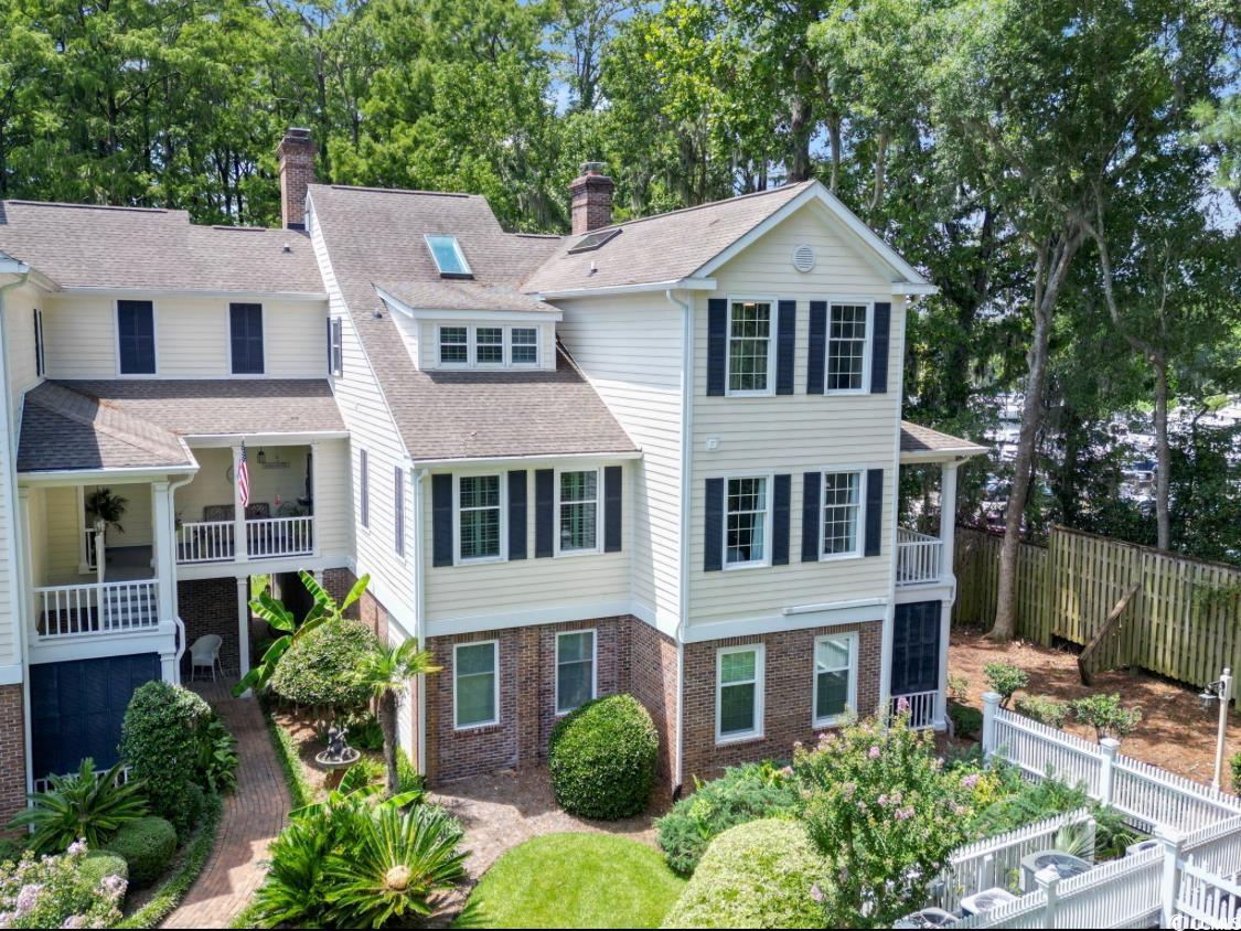 1970 Governors Landing Road, Unit 201 Murrells Inlet, SC 29576 - Photo 1 of 25 View of front of house with brick siding, a chimney, roof with shingles, and view of scattered trees