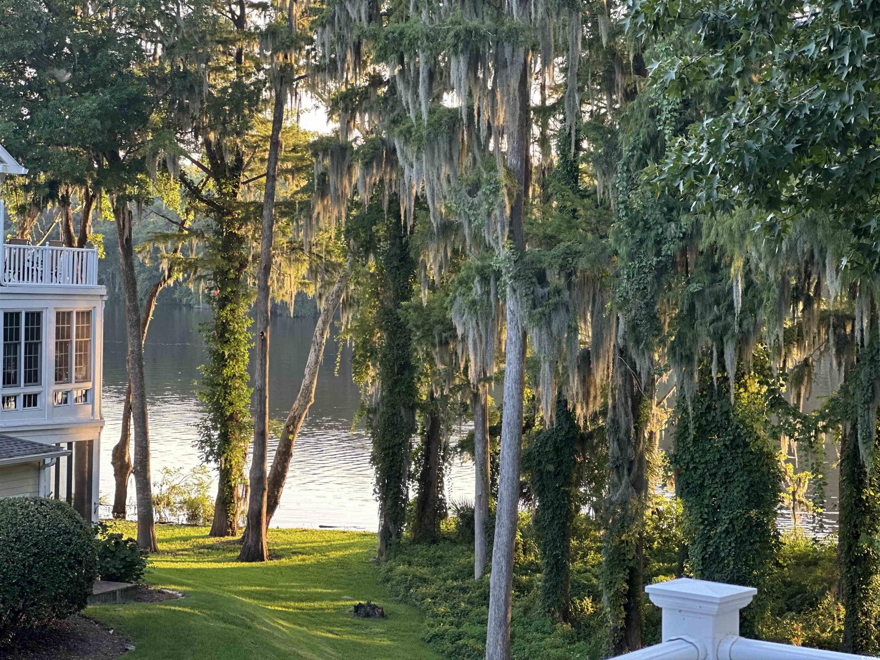 1970 Governors Landing Road, Unit 201 Murrells Inlet, SC 29576 - Photo 21 of 25 View of yard with a water view from screened in porch on main level.