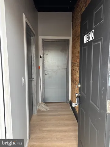 a view of a hallway with wooden floor and a hallway