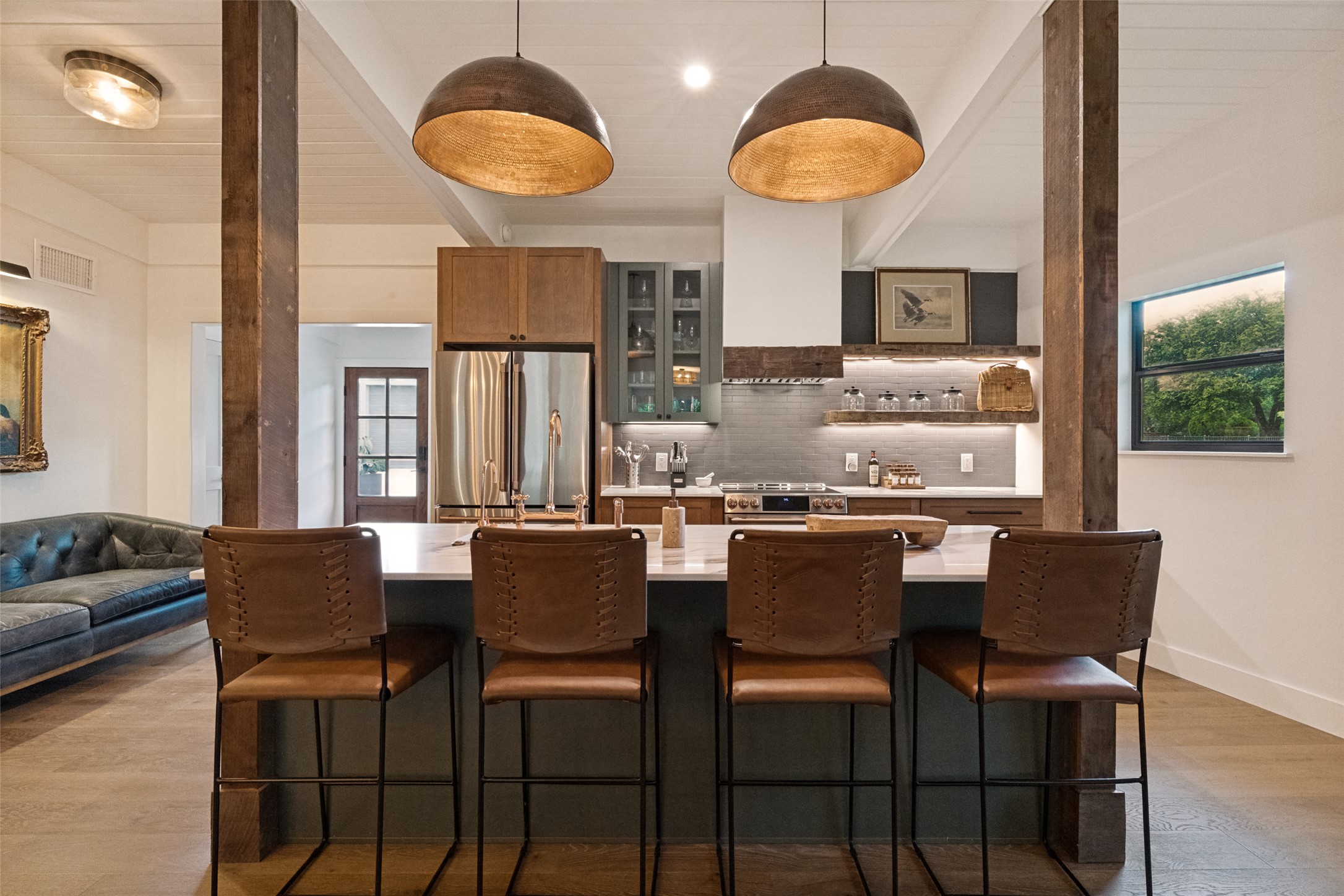 303 Lago Verde Road Austin, TX 78734 - Photo 10 of 39 Custom cabinetry and warm wood accents define this inviting kitchen space, perfect for entertaining.