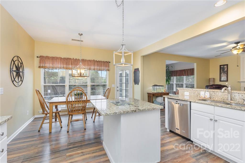 154 Coronilla Road Mooresville, NC 28117 - Photo 12 of 38 a living room with granite countertop kitchen island furniture and a chandelier