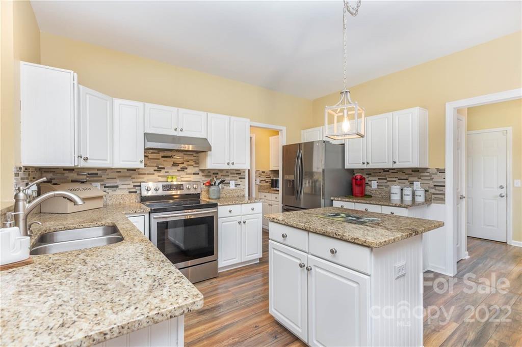 154 Coronilla Road Mooresville, NC 28117 - Photo 15 of 38 a kitchen with stainless steel appliances granite countertop a sink stove and refrigerator