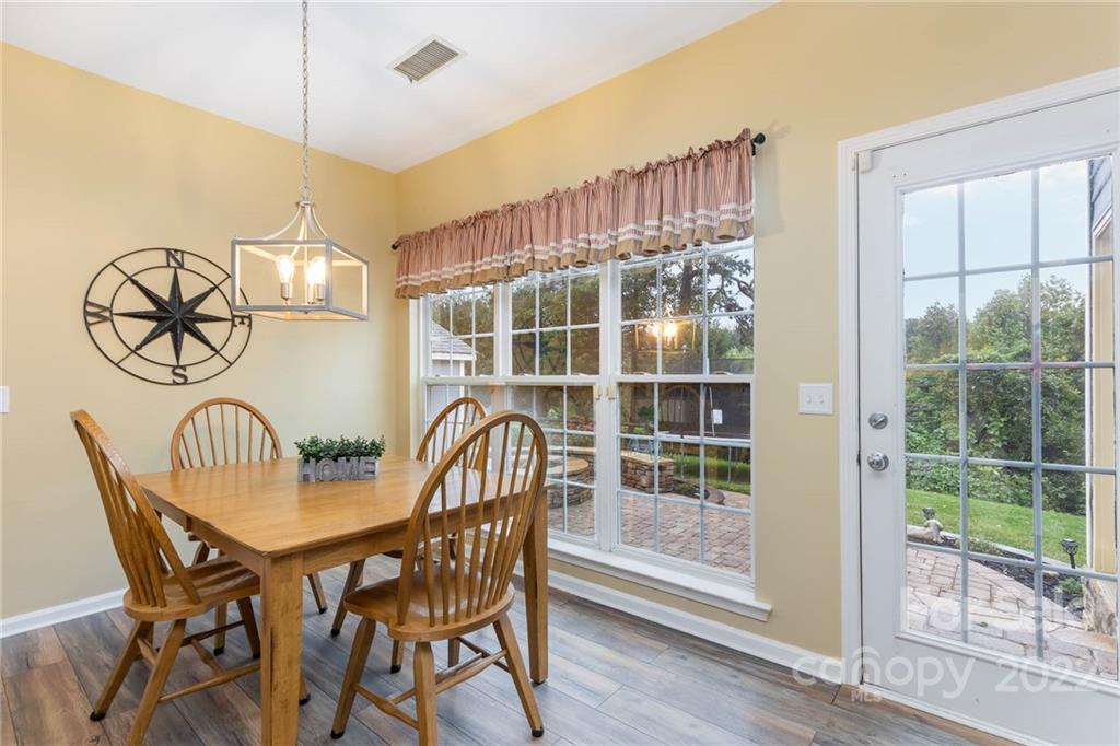 154 Coronilla Road Mooresville, NC 28117 - Photo 16 of 38 a view of a dining room with furniture wooden floor and next to a window