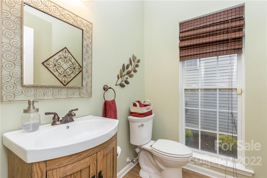 154 Coronilla Road Mooresville, NC 28117 - Photo 18 of 38 a bathroom with a sink a toilet and a mirror