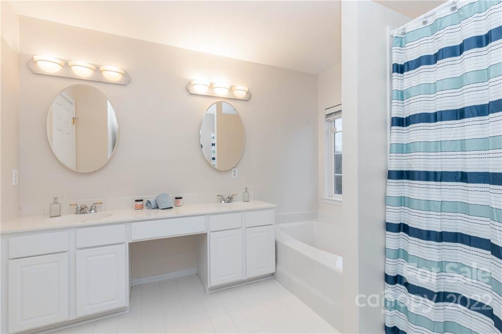 154 Coronilla Road Mooresville, NC 28117 - Photo 22 of 38 a bathroom with a double vanity sink mirror and bathtub