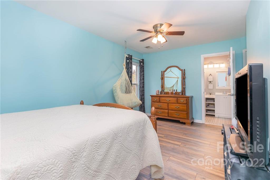 154 Coronilla Road Mooresville, NC 28117 - Photo 25 of 38 a bedroom with a bed and a flat tv screen on dresser