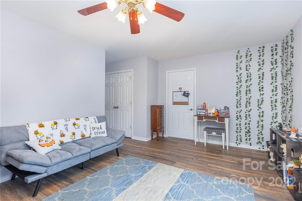 154 Coronilla Road Mooresville, NC 28117 - Photo 29 of 38 a living room with furniture and a baby crib