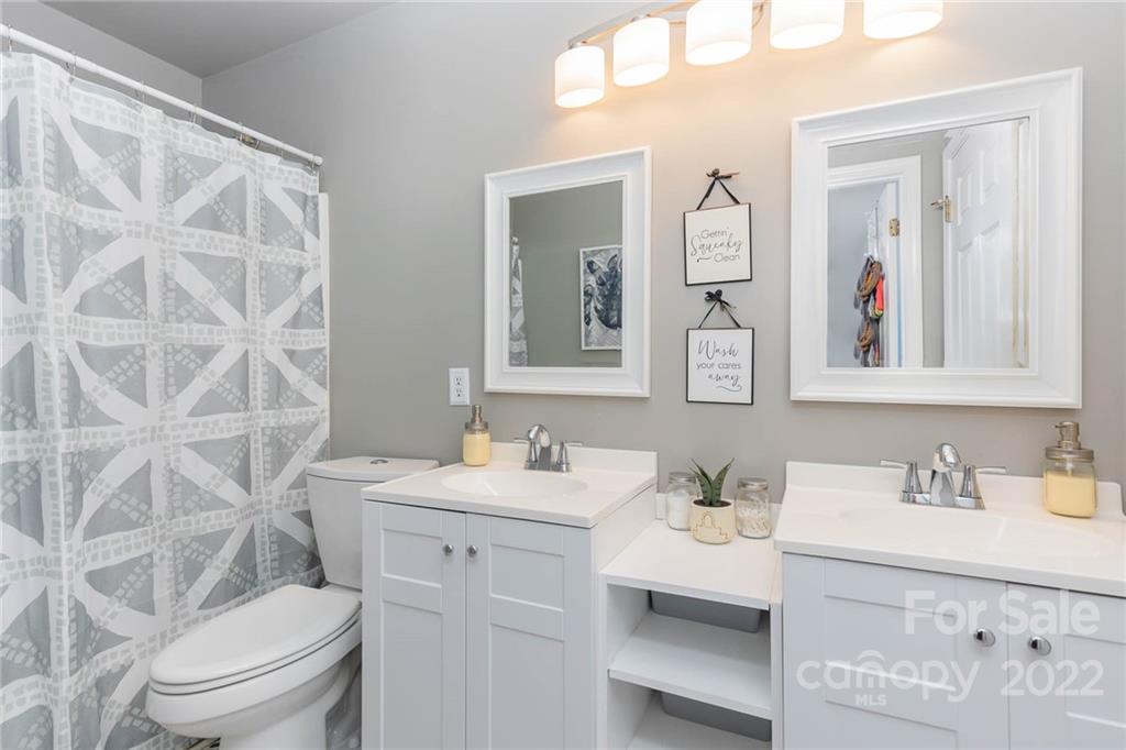 154 Coronilla Road Mooresville, NC 28117 - Photo 30 of 38 a bathroom with a sink vanity mirror and toilet