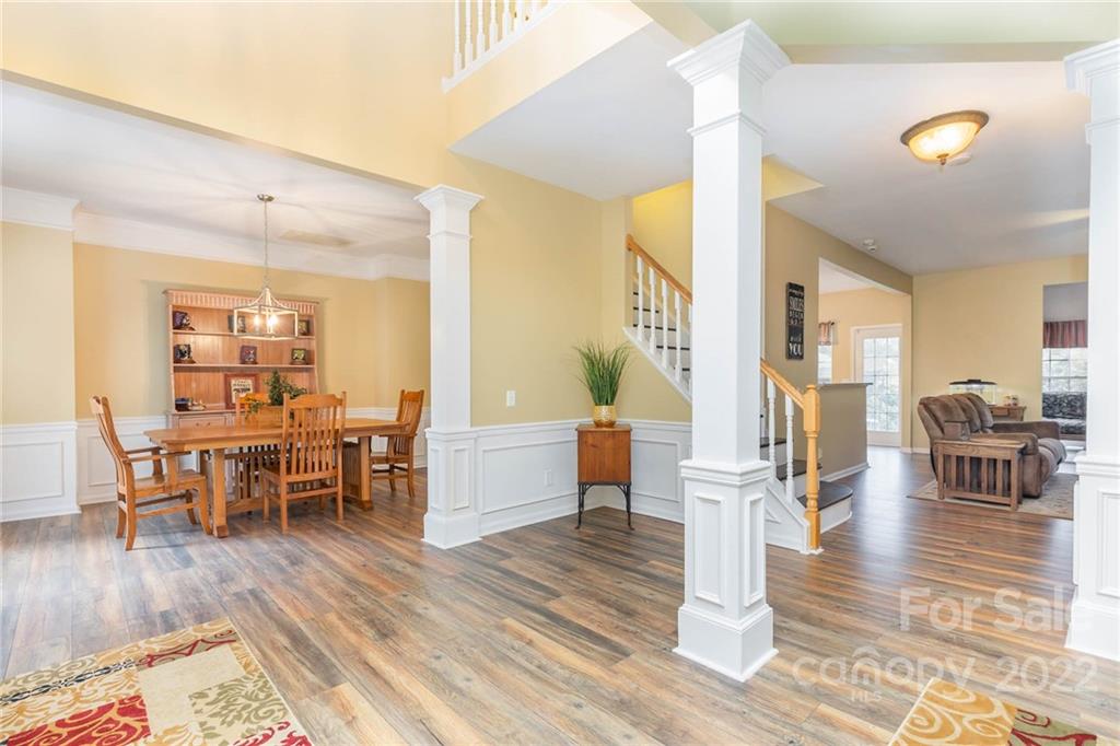 154 Coronilla Road Mooresville, NC 28117 - Photo 3 of 38 a living room with furniture and a dining table with wooden floor