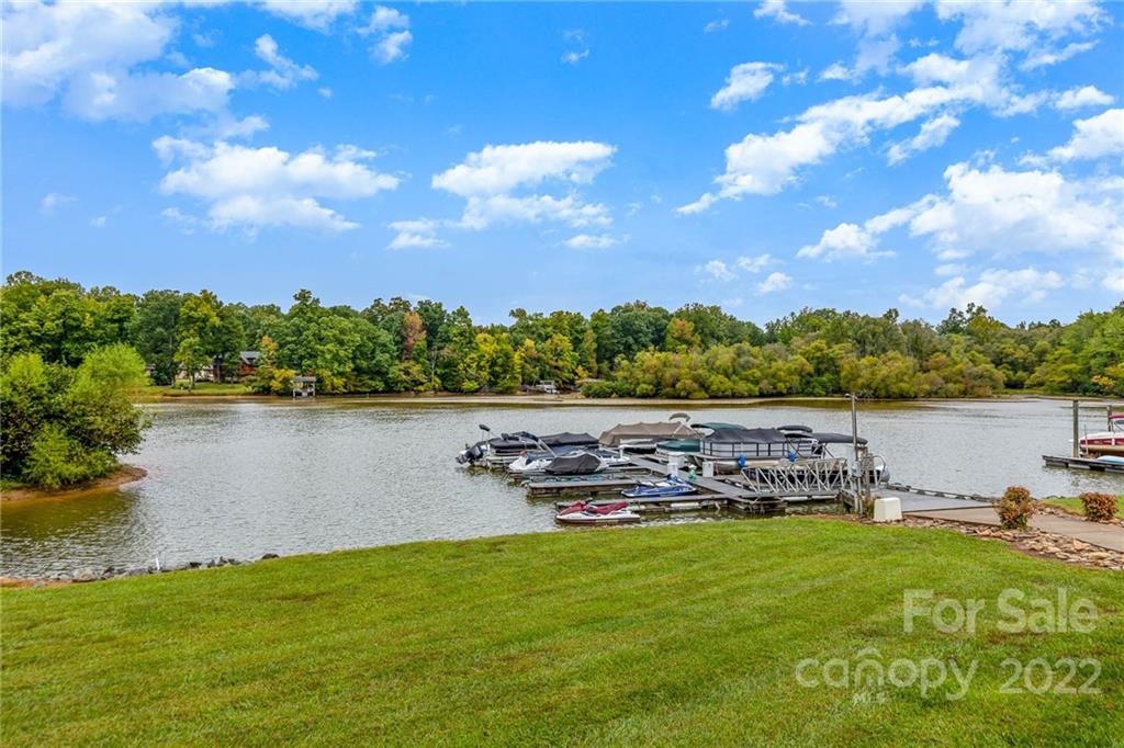 154 Coronilla Road Mooresville, NC 28117 - Photo 36 of 38 a view of a lake with houses in the back